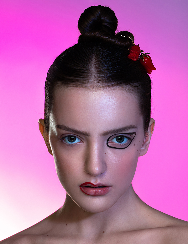 Asymmetrical graphic makeup on a girl with dark hair