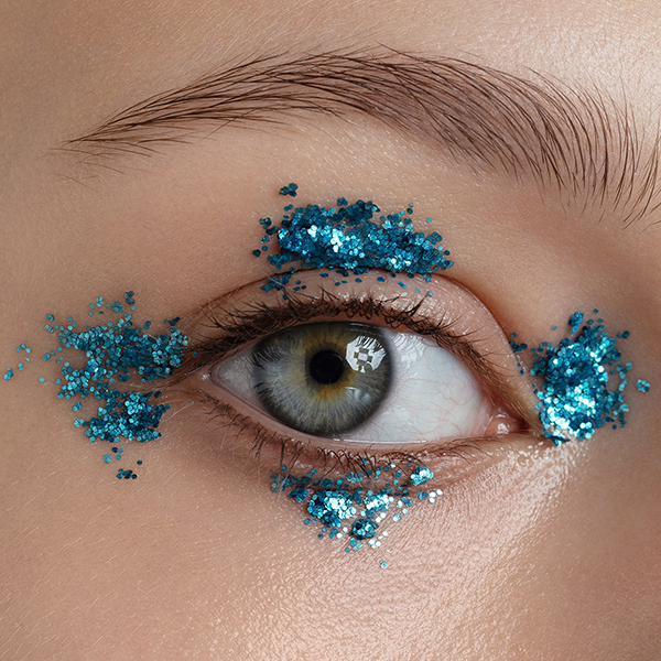 Close-up macro eye with blue glitter on it