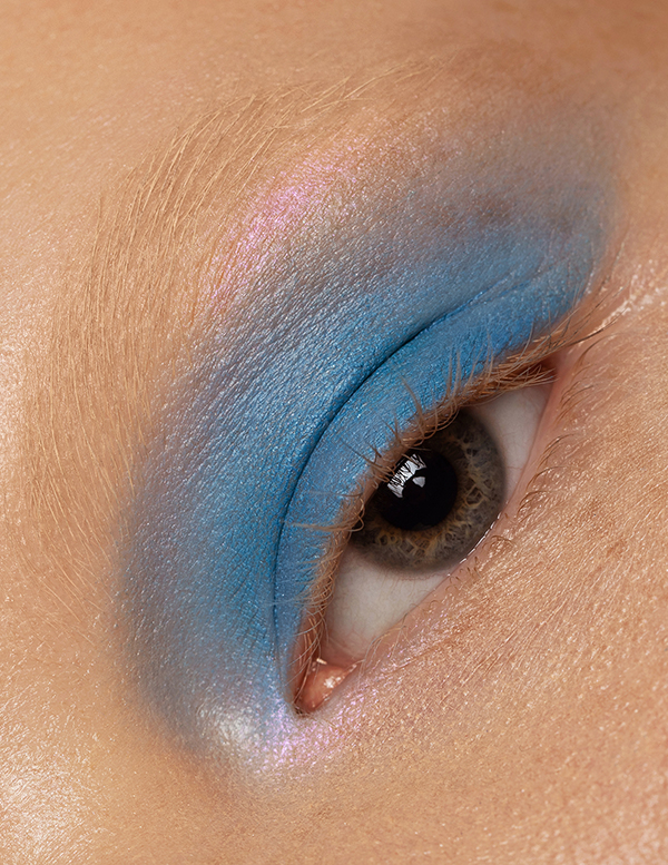 Light blue eyeshadow on pale skin captured on a close-up macro eye